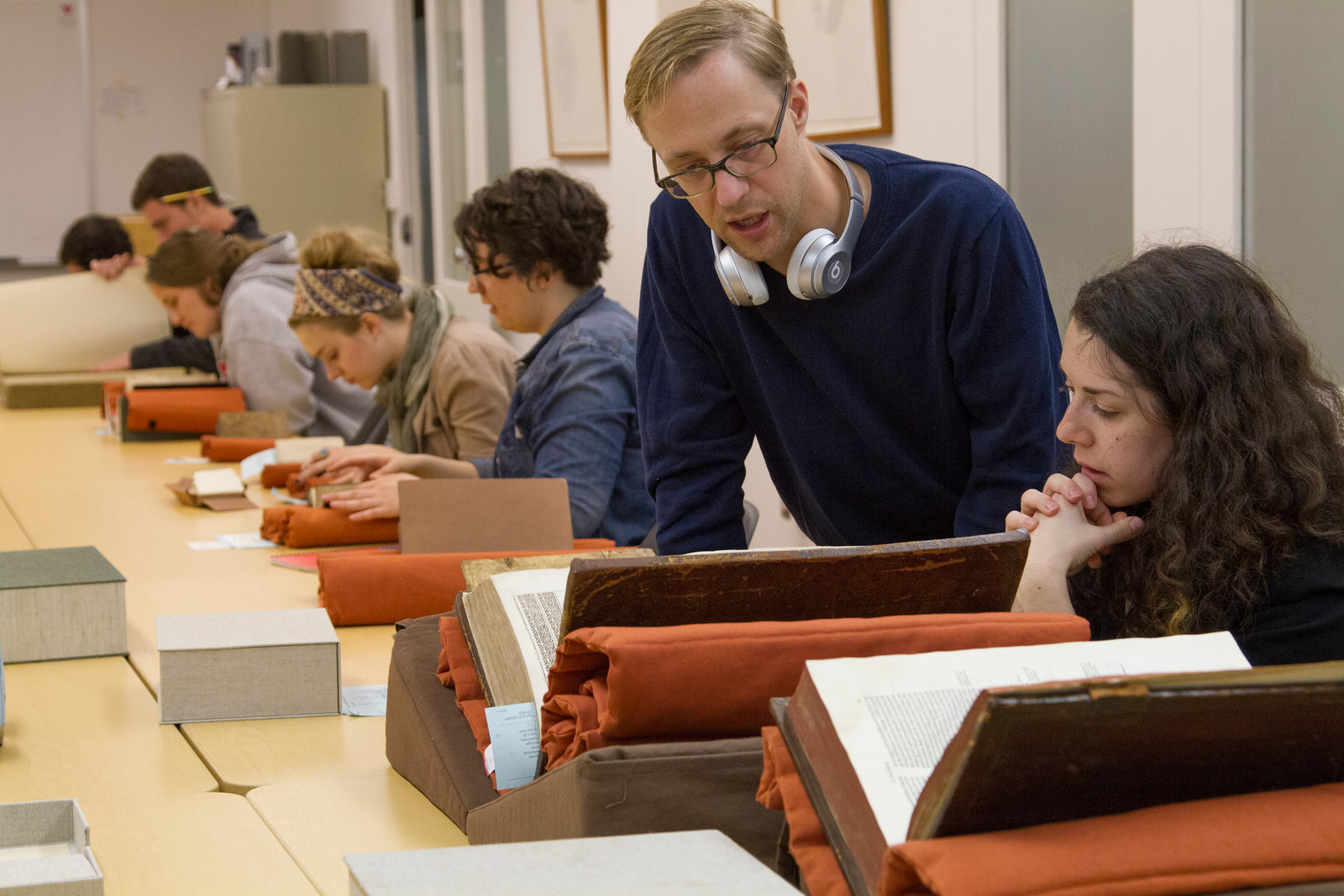 Researchers looking at archival bound volumes